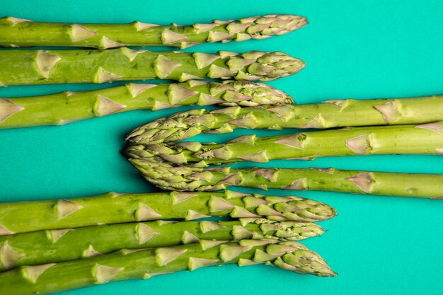 Organic green asparagus on green background