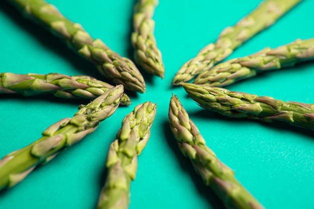 Organic green asparagus on green background