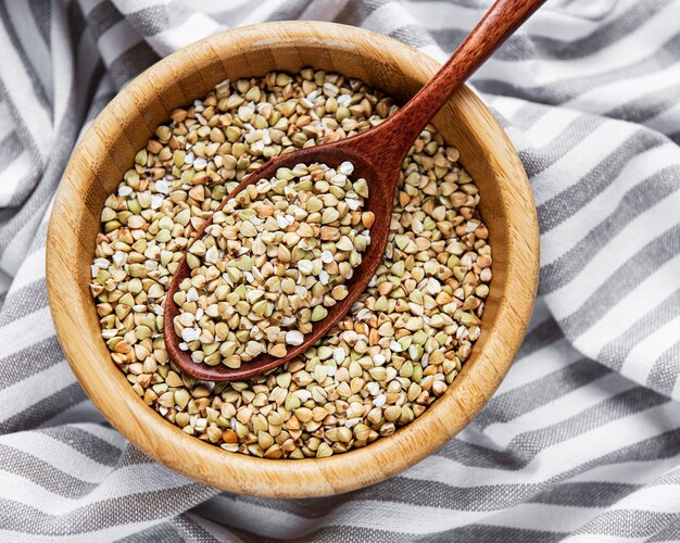 Organic green buckwheat on a grey textile background