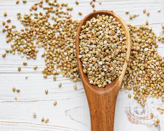 Organic green buckwheat on a white wooden table