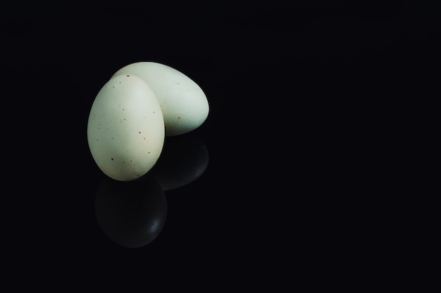 Organic green eggs on a black surface