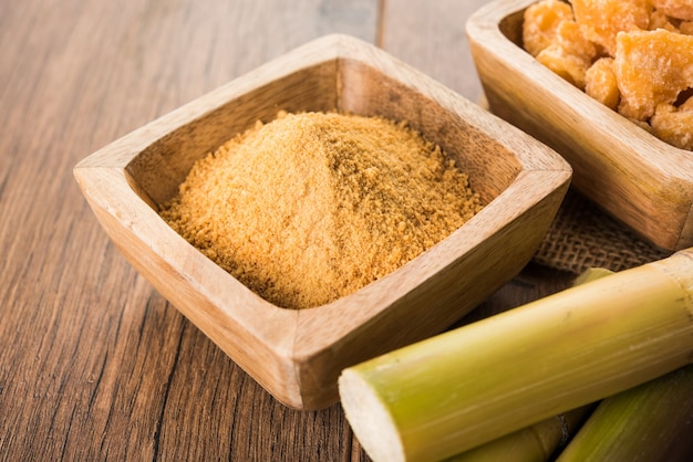 Organic Gur or Jaggery Powder is unrefined sugar obtained from concentrated sugarcane juice. served in a bowl. selective focus