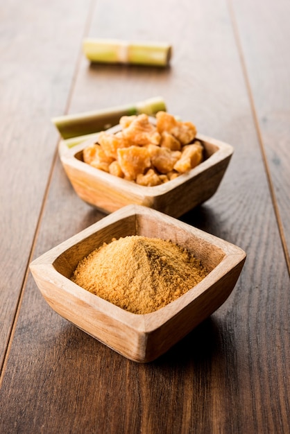 Organic Gur or Jaggery Powder is unrefined sugar obtained from concentrated sugarcane juice. served in a bowl. selective focus