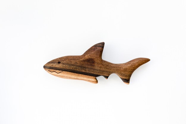 Photo organic hand made wooden shark toy isolated on white