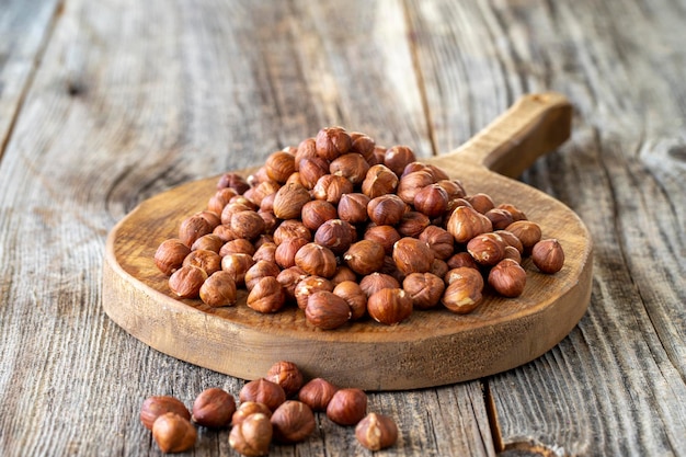 Organic Hazelnut Hazelnuts on wood background Bulk Hazelnut kernels