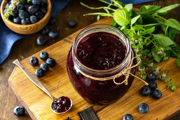 Organic Homemade Preserves Blueberry jam in a jar and fresh blueberries Free space for your text