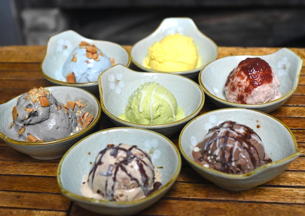 Organic ice cream in bowls on wooden background closeup