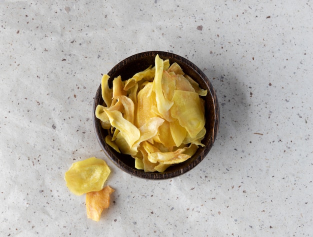 Organic jackfruit chips on paper background with copy space