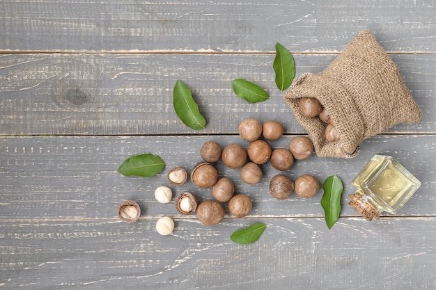 Organic Macadamia nut on wooden table - vintage filter.