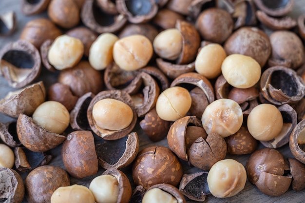 Organic Macadamia nuts and shell on wooden table