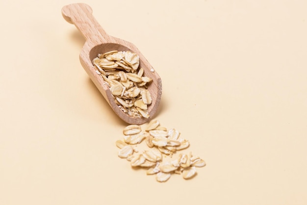 Organic oatmeal oat flakes with wooden scoop concept for healthy eating and nutrition horizontal