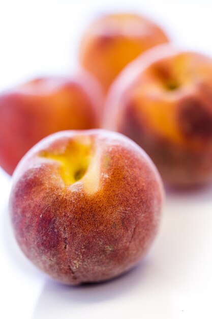 Organic peaches on a white background.