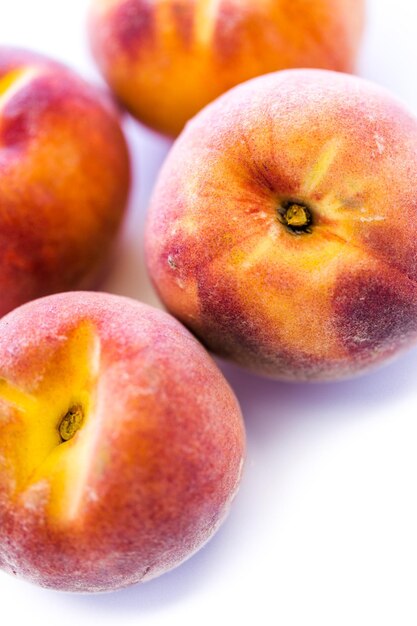 Organic peaches on a white background.