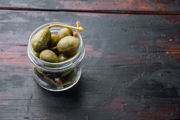 Organic pickled, canned capers, on old wooden table