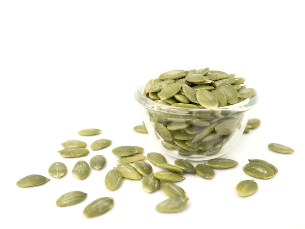 Organic pumpkin seeds in a circle shaped glass bowl