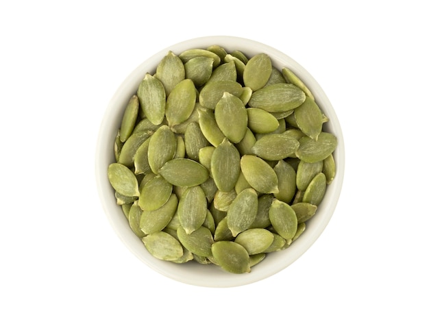 Organic pumpkin seeds in white ceramic bowl