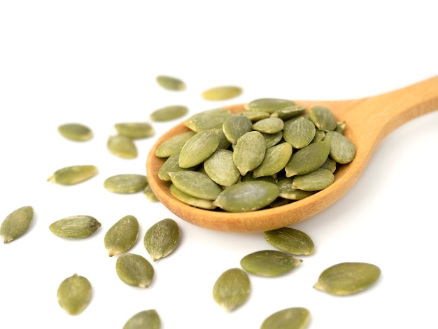 Organic pumpkin seeds in wooden spoon