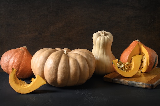 Organic pumpkins on beige background autumn harvest for thanksgiving day or halloween party
