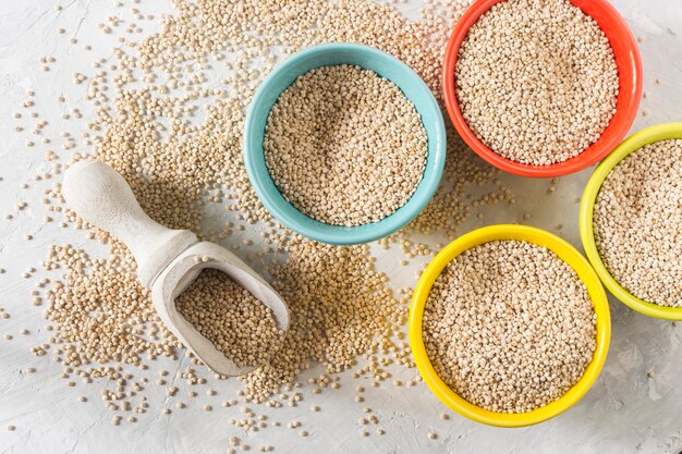 Organic quinua cereal in color bowl on white background