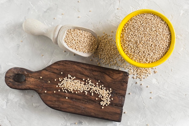 Organic quinua cereal in color bowl on white background