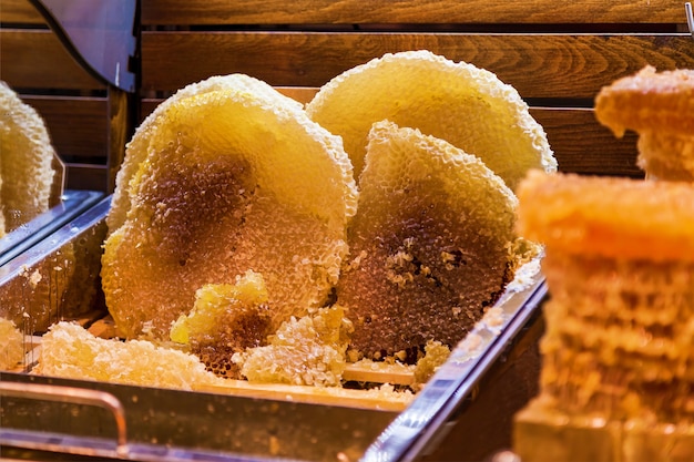 Organic raw honeycombs on wooden board, flower honey on savior of the honey feast day. Eastern slavic folk holiday, Spas day