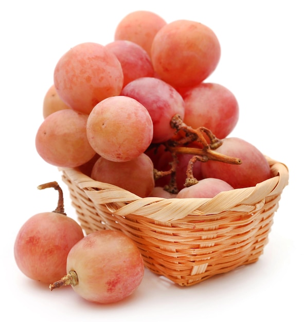 Organic red grapes over white background