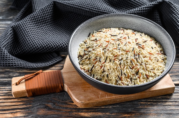 Organic rice, Mixed rice in a bowl. Black background. Top view