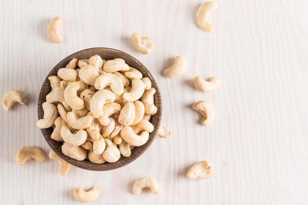 Organic roasted cashew nuts in a wooden bowl Top view