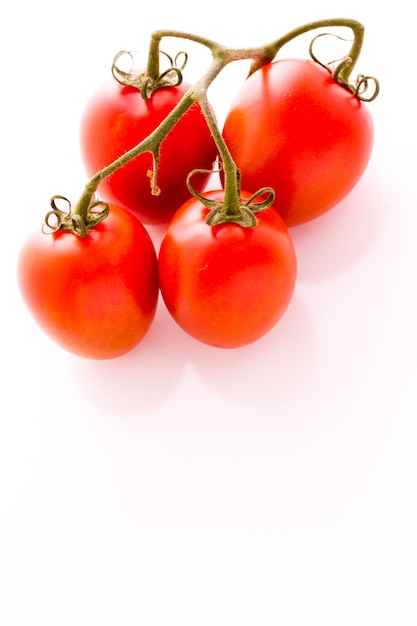 Organic Roma tomatoes on white background.