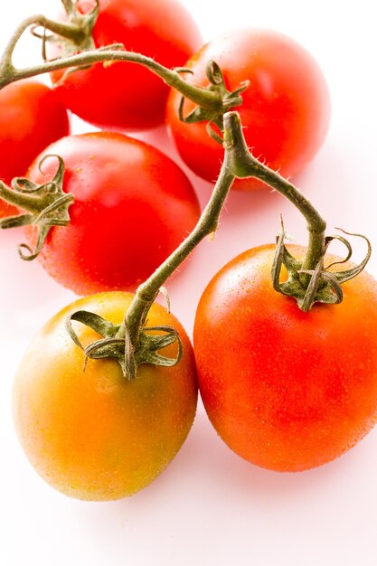 Organic Roma tomatoes on white background.