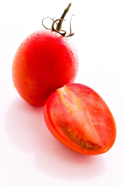 Organic Roma tomatoes on white background.