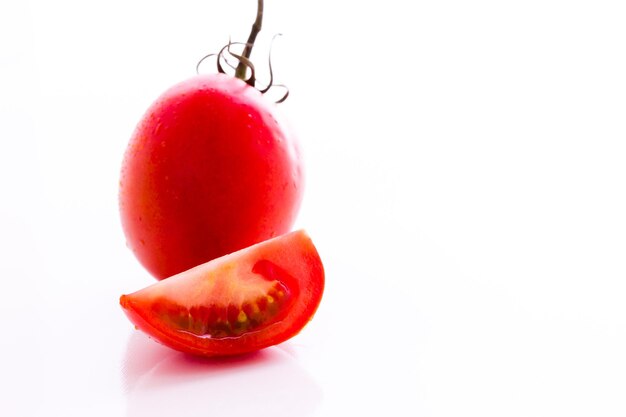 Organic roma tomatoes on white background