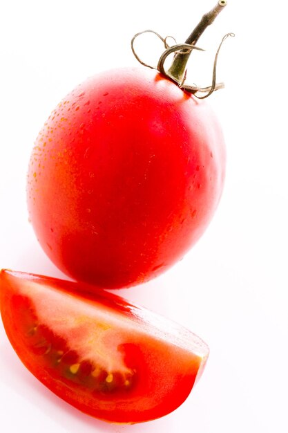 Organic Roma tomatoes on white background.