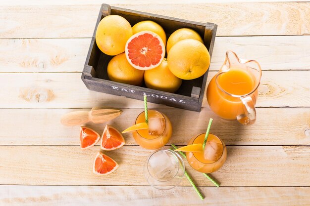 Organic ruby red grapefruit juice in small glass with ice.