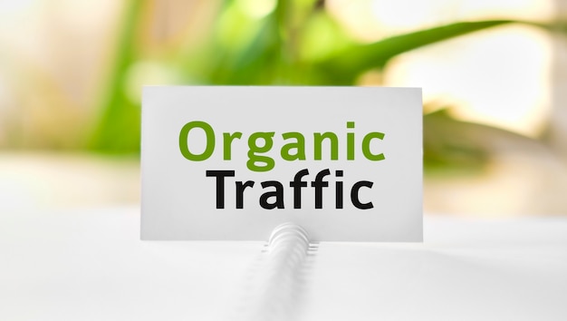 Organic seo traffic - business seo concept text on a white notebook and green flowers