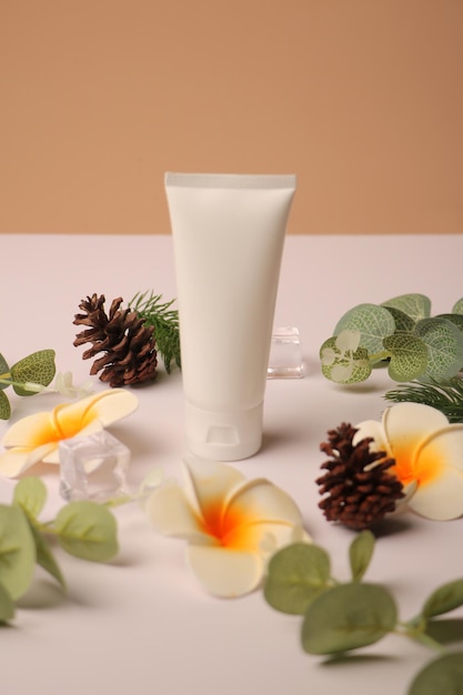 organic skincare tube with natural elements pinecones plumeria flowers and greenery