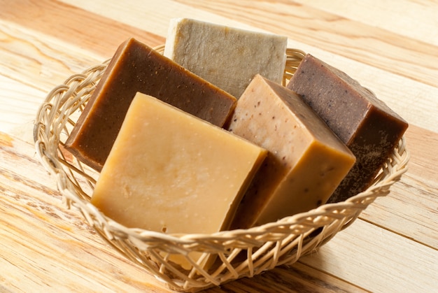 Photo organic soap bars in a basket on a wooden table