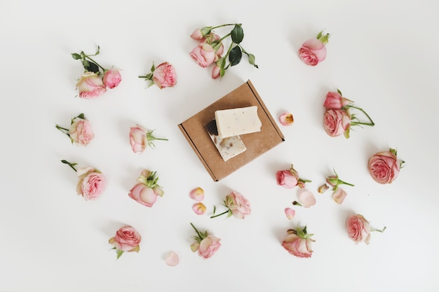 organic soap bars in a craft gift box with flowers on a floral surface top view