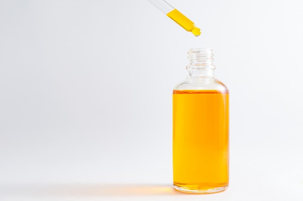 Organic SPA cosmetics with herbal ingredients: vitamin C serum in cosmetic bottle with dropper.