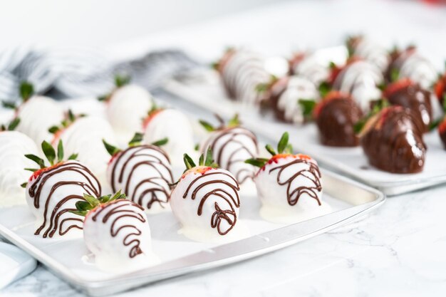 Organic strawberries dipped in chocolate drying on a parchment paper.