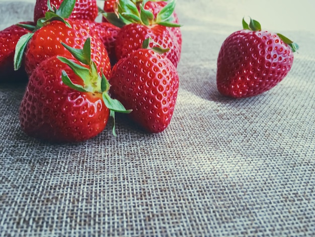 Organic strawberries on rustic linen background