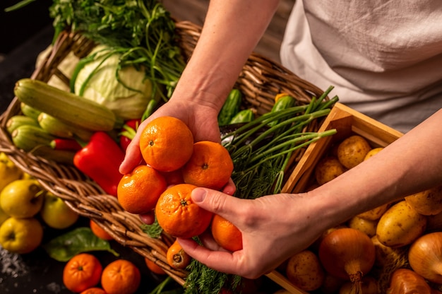 Organic vegetables farmers hands with freshly picked apples fresh organic apples fruits and vegetabl...