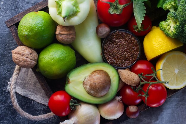 Organic vegetables,fruit, herbs,nuts,seeds in wooden box for healthy lifestyle, raw vegan diet, selective focus, top view