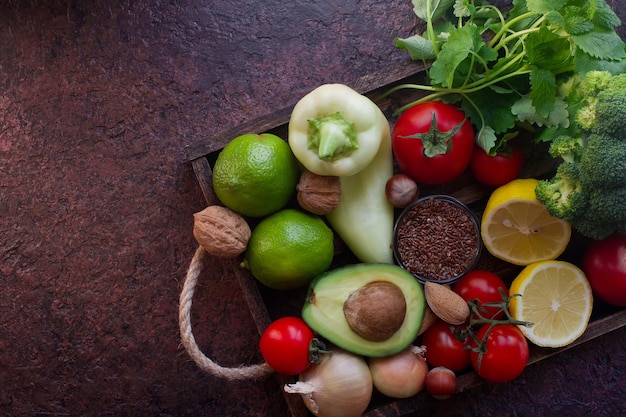 Organic vegetables,fruit, herbs,nuts,seeds in wooden box for healthy lifestyle, raw vegan diet, selective focus, top view