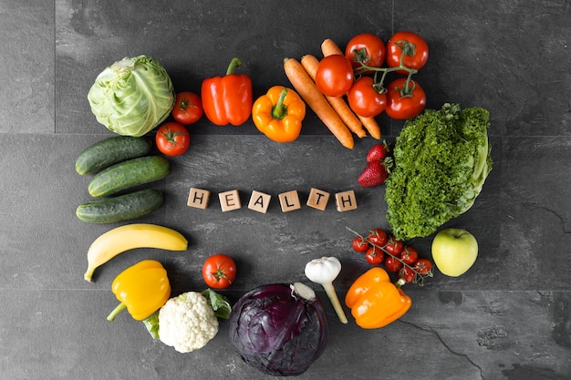 Organic vegetables and fruits Text Health on Wooden cube