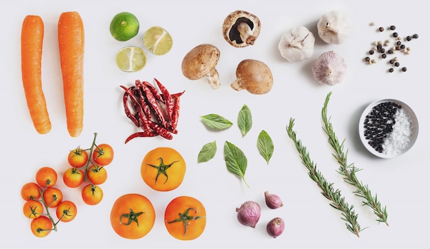 Organic vegetables with herbs and spices, on white background