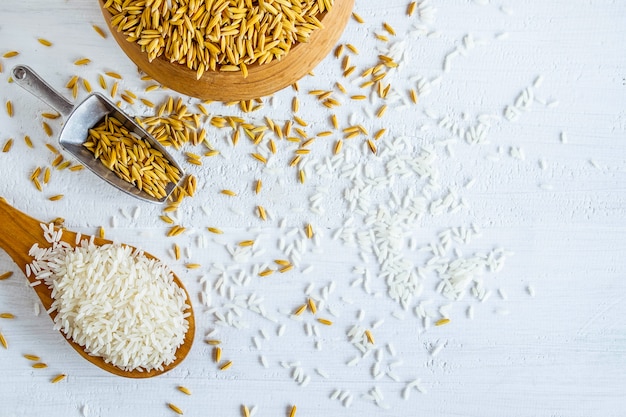 Organic white rice and paddy on a wooden table