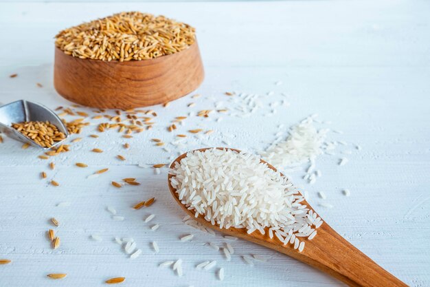 Organic white  rice and paddy on a wooden table