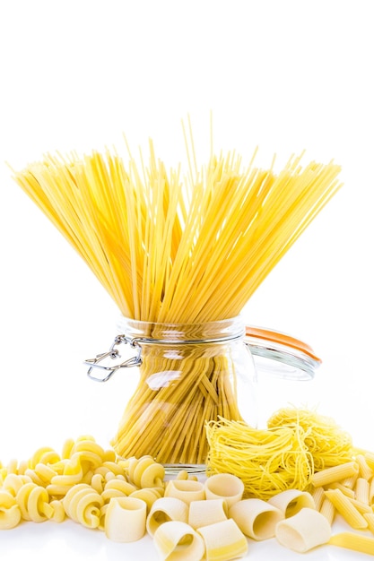 Organic yellow pasta on a white background.