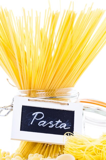 Organic yellow pasta on a white background.